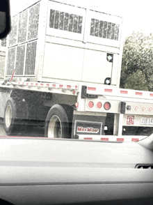 a white truck with a max miser sign on the back