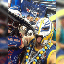 a man wearing a los bills jersey stands next to another man wearing a mask