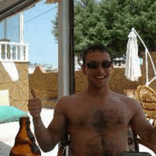 a shirtless man is giving a thumbs up while holding a beer bottle .