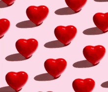 a seamless pattern of red hearts on a pink surface