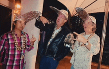 three men wearing aluminum foil hats and chains are posing for a photo