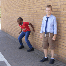 a boy wearing a red shirt with chevrolet on it