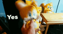 a person is petting a stuffed animal that says yes on it