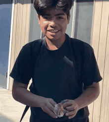 a boy with braces on his teeth is smiling and holding a piece of bread