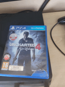 an uncharted 4 video game is sitting on a playstation