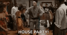 a man is dancing at a house party with a crowd of people .