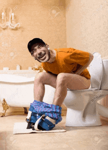 a man sits on a toilet with his pants down