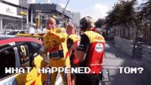 a group of men are standing in front of a car with the words what happened tom written on the bottom