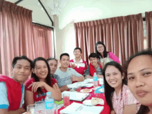 a group of people sitting around a table with a man wearing a shirt that says ' star ' on it