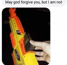 a person is holding a yellow nerf gun in their hand .