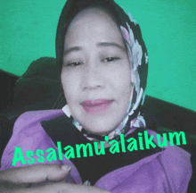 a woman wearing a scarf and a purple jacket says assalamu'alaikum