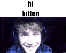 a young man wearing headphones is smiling with the words hi kitten above him