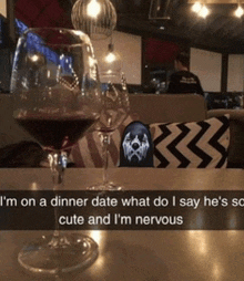 a glass of wine sits on a table with a caption that says " i 'm on a dinner date