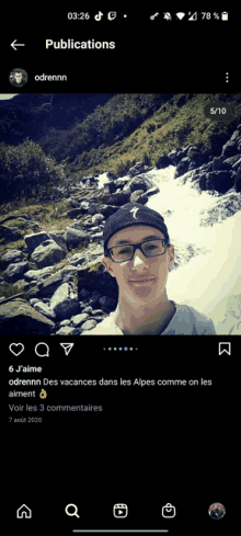 a phone screen shows a photo of a young man with glasses and a waterfall in the background