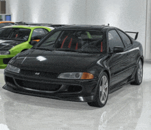 a black car with the letter r on the front is parked next to a green car