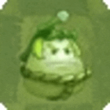 a green cartoon character with a hat on his head is sitting on a green surface .