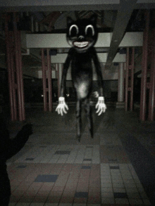 a cartoon cat with a big smile on its face is standing in the dark