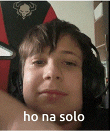 a young boy wearing headphones says ho na solo on the bottom