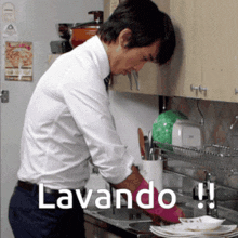 a man in a white shirt and tie is washing dishes in a kitchen with the words lavando written on the bottom