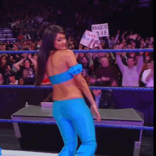 a woman in a blue outfit is holding a sign that says vanslynx