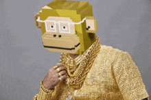 a man with a monkey mask on his head is wearing gold jewelry