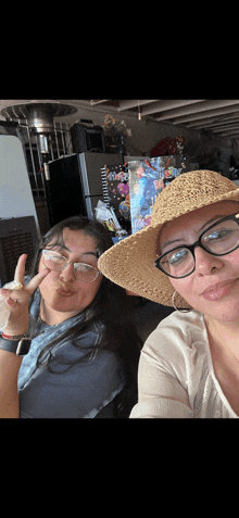 two women wearing hats and glasses are posing for a photo