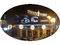 the cafe de palm is lit up at night with a star above it