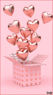 pink hearts are coming out of a pink box