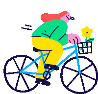 a woman is riding a bike with a basket of flowers