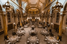 a large room with tables and chairs set up for a banquet .