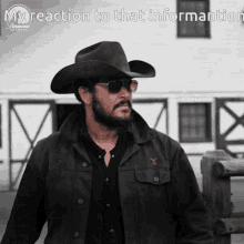 a man wearing a cowboy hat and sunglasses stands in front of a barn with the words " my reaction to that information " below him