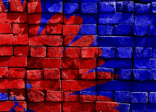 a red and blue brick wall with a blue arrow painted on it