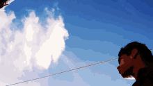 a man looking up at a blue sky with clouds