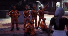 a group of people wearing orange jumpsuits with the letters snc on them