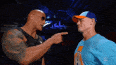 the rock and john cena are pointing at each other in front of a wwe logo