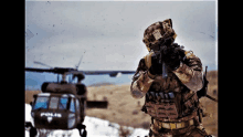 a soldier standing in front of a helicopter that says polis