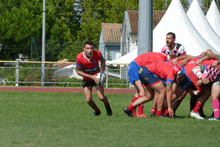 a rugby player wearing a red jersey that says actibank