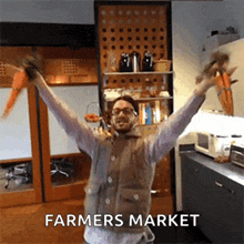 a man in a vest is holding carrots in his hands in a kitchen with the words farmers market above him