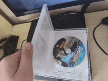 a person is holding a dvd case with a disc that says forza horizon 2