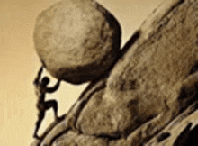 a person is pushing a large rock up a hill .