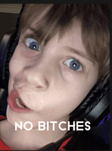 a young boy wearing headphones is making a funny face with the words no bitches below him