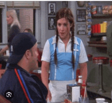 a man and woman are sitting at a table in a diner .