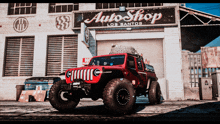 a jeep is parked in front of an auto shop