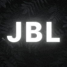 the word jbl is glowing in the dark surrounded by leaves