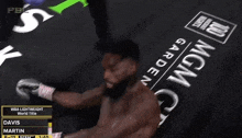 a man is boxing in front of a sign that says mgm