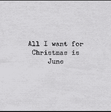 all i want for christmas is june is written on a piece of paper on a typewriter .