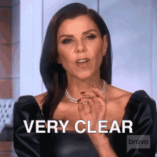 a woman says " very clear " while wearing a necklace