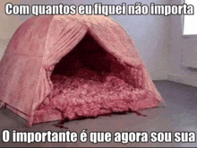 a pink tent filled with blood is sitting on the floor .