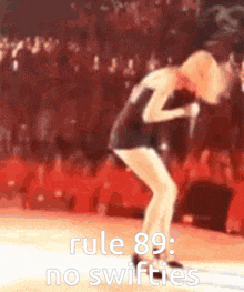 a blurred image of a woman singing with the words rule 89 no swifties below her