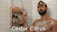 a man is taking a shower with the words cedar citrus written on the bottom